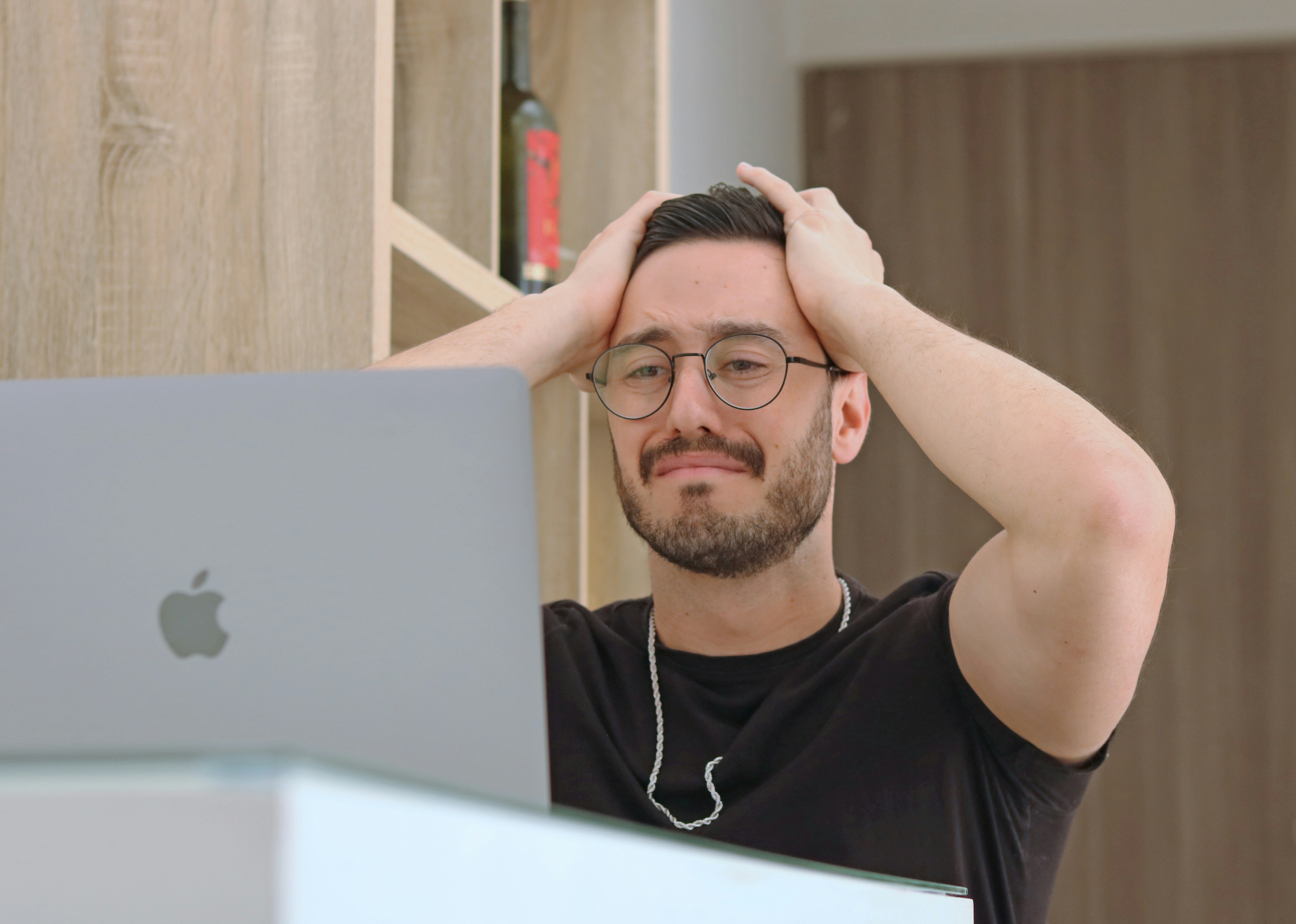 Frustrated business owner looking at a computer screen